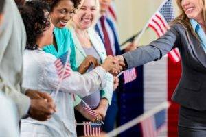Woman politician shaking hands with voters and connecting with voters. Successful political campaign